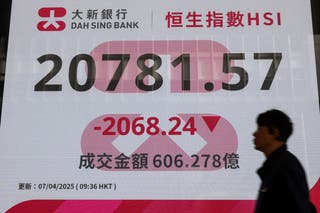 A screen displaying the Hang Seng stock index is seen at Central district, in Hong Kong